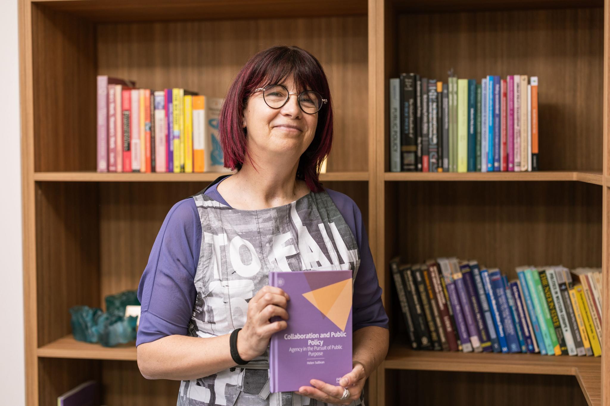 The College Dean, Professor Helen Sullivan, holds her recently published book.