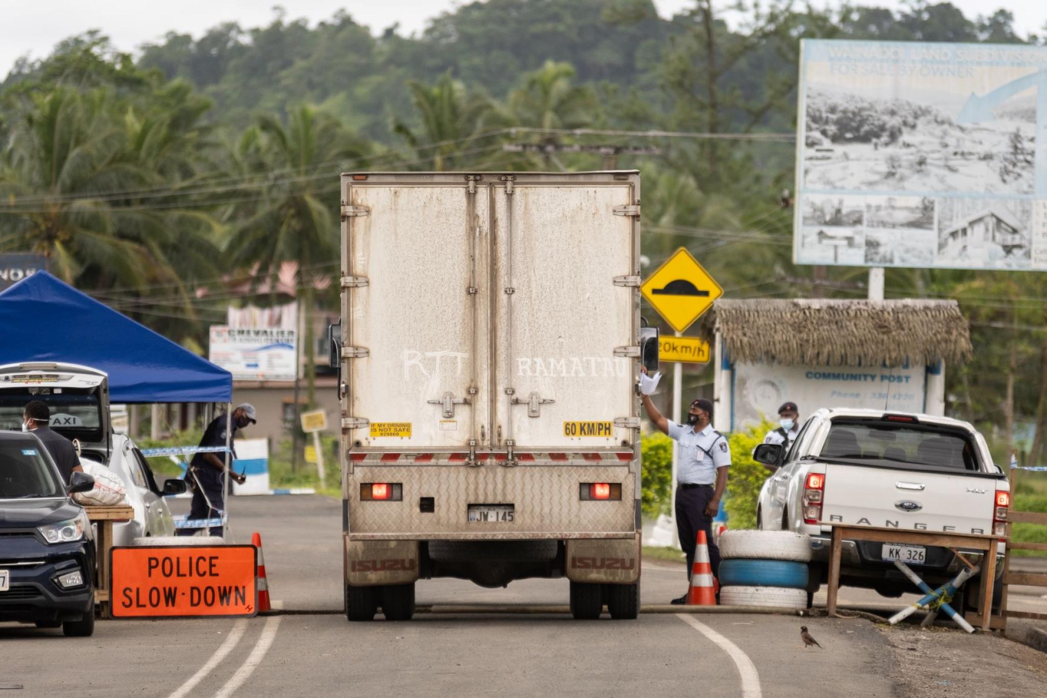 Police checking a vehicle's authorisation to travel from one containment zone to another during the peak of Fiji's second COVID 19 outbreak. 