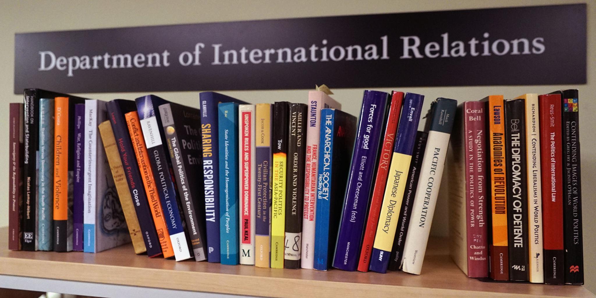 ANU Dept of IR books on shelf. Photo credit: Olivia Wenholz