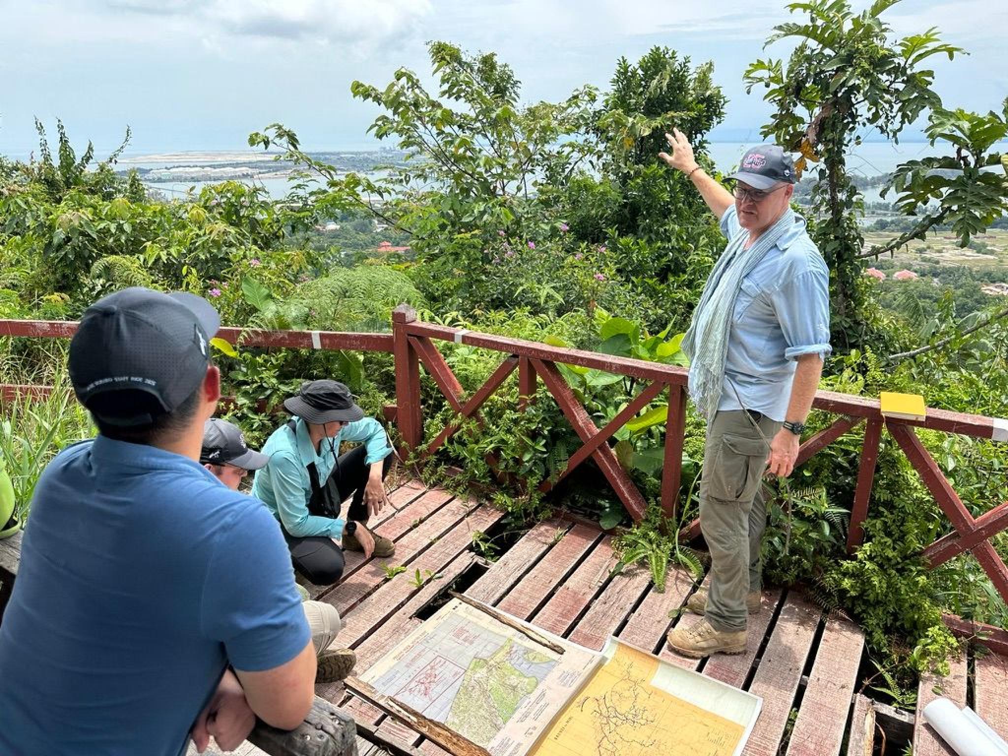 Associate Professor Garth Pratten discussing the strategic and operational significance of Brunei Bay to the Borneo campaign of 1945. The vantage point is the summit of Bukit Tempayan Pisang (722m), which was the site of a Japanese observation post prior to the Australian landings on 10 June 1945. 