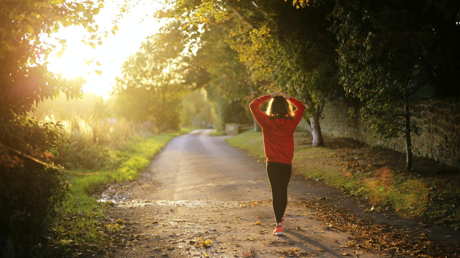 Woman walking at sunrise