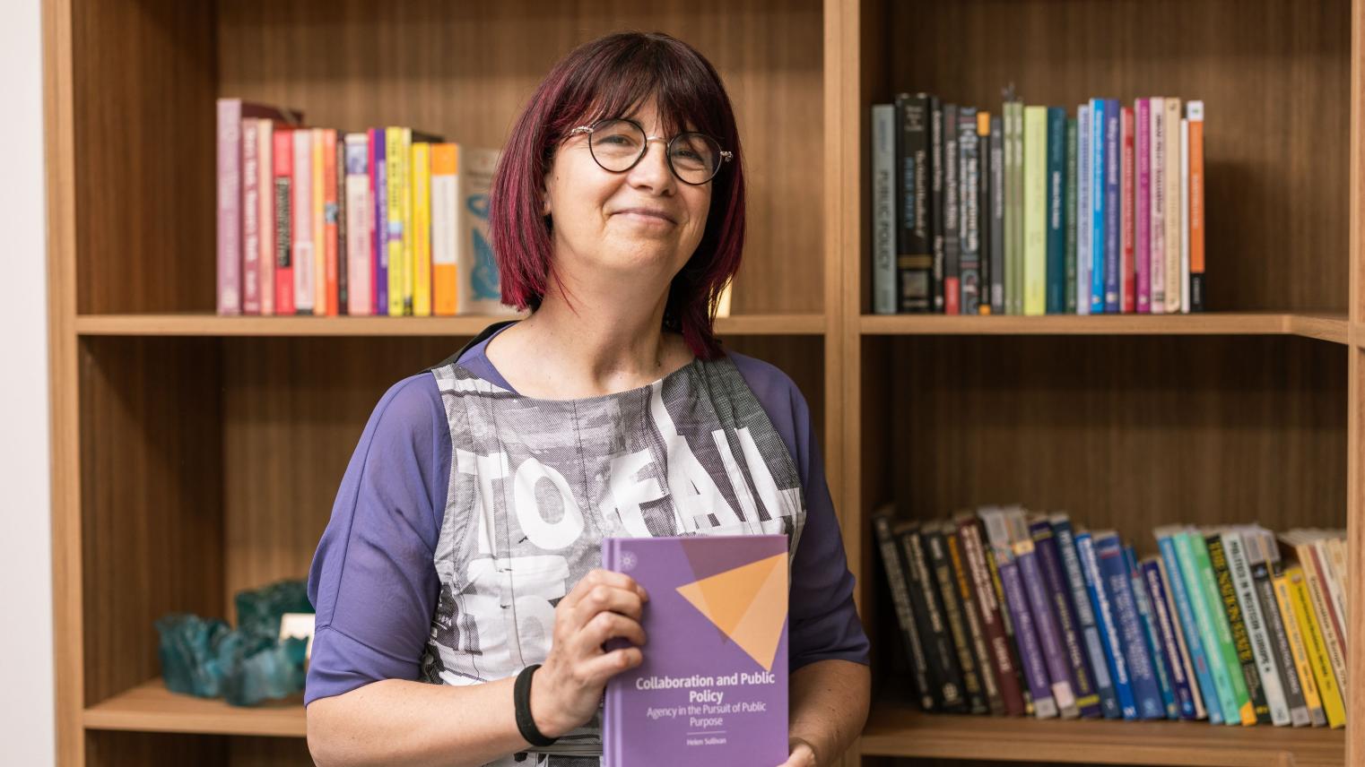 The College Dean, Professor Helen Sullivan, holds her recently published book.